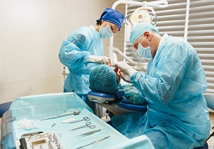 an oral surgeon performing dental implant placement