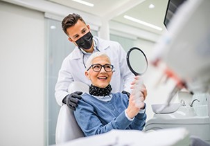 a patient checking her new dental implant restorations