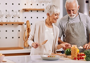 Man and woman cooking healthy food